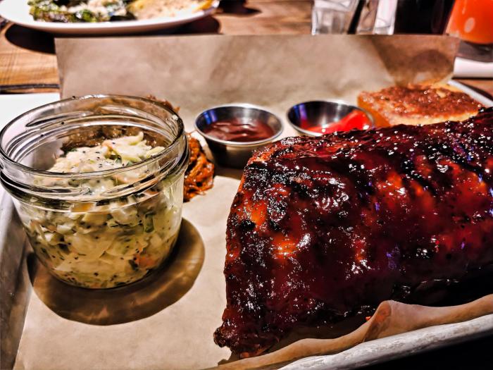 House-smoked Baby Back Ribs and pulled pork with a side of coleslaw at the Draft Room in Rosemont